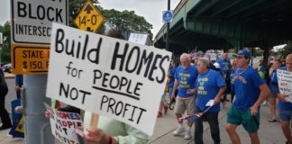 Protesting over-development of luxury housing, Stand Up For Eastie takes to the streets