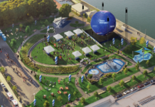 A big soccer ball is coming to East Boston’s waterfront Aerial view of a waterfront festival with white tents, a circular lawn, a large blue inflatable stage, seating areas, and a water feature.