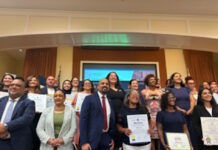Latinos for Education Honors Brooke Charter School Multilingual Learner Coordinator Lesley Peña Group of diverse professionals posing with certificates at an awards or graduation event in a conference room.
