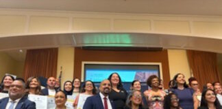 Latinos for Education Honors Brooke Charter School Multilingual Learner Coordinator Lesley Peรฑa Group of diverse professionals posing with certificates at an awards or graduation event in a conference room.