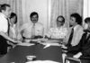 Gina Fiandaca: Appreciating John Vitagliano, who always believed in people Six professionals in a office meeting around a long conference table; a man stands presenting papers to seated colleagues.